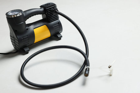 One modern tire inflator on light background