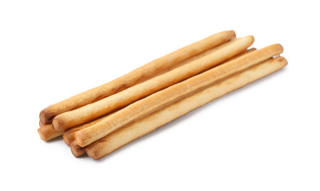 Many delicious grissini sticks isolated on white