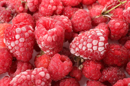 Many frozen raspberries on table, top view