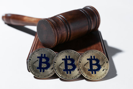 Cryptocurrency. Bitcoins and judge's gavel on white background, closeupの写真素材