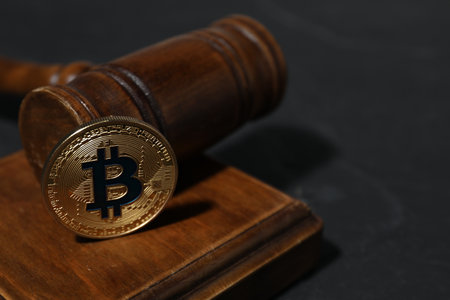 Cryptocurrency. Bitcoin and judge's gavel on black table, closeup. Space for textの写真素材