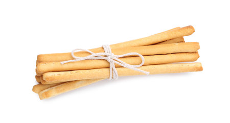 Many delicious grissini sticks isolated on white