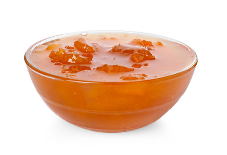 Tasty apricot jam in glass bowl isolated on whiteの写真素材