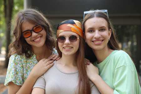 Portrait of happy friends with sunglasses outdoors
