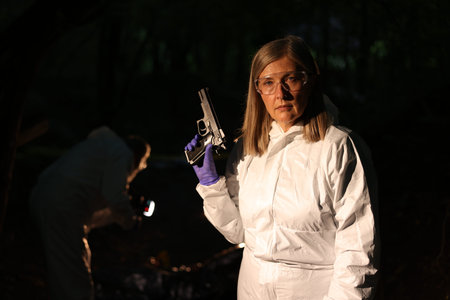 Forensic experts working at crime scene with dead body outdoors, selective focus