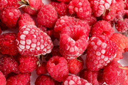 Many frozen raspberries on table, top view
