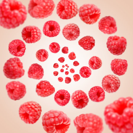 Fresh raspberries swirling in air against beige background
