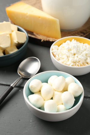 Different dairy products on gray wooden table, above view