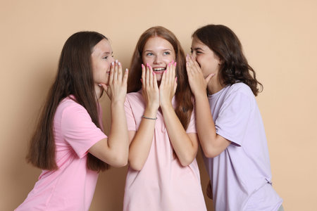 Portrait of happy friends on beige background