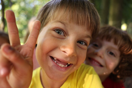 Cute little kids taking selfie in park, selective focus