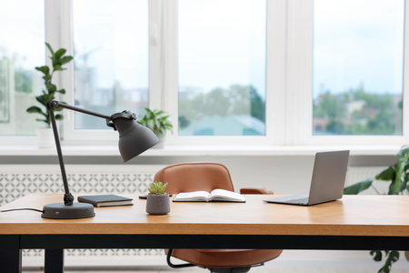 Stylish workplace with modern laptop and stationery on wooden desk indoors