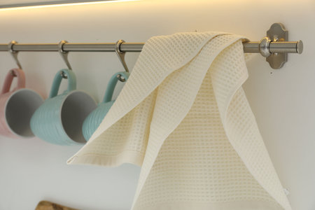 Clean waffle towel and cups hanging in kitchen, closeupの写真素材