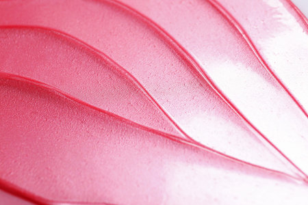 Texture of pink lip gloss as background, closeup