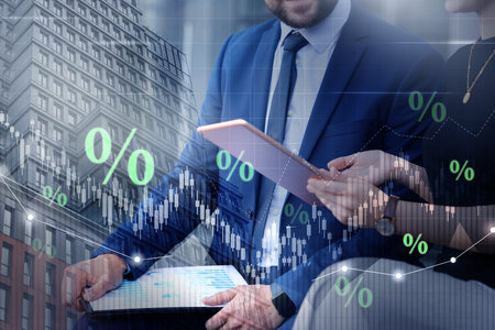 Percent signs, graphs, building and businesspeople, double exposure