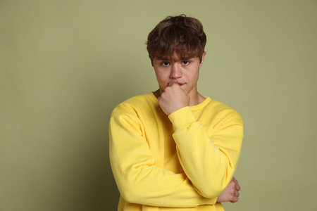 Teenage boy on green background
