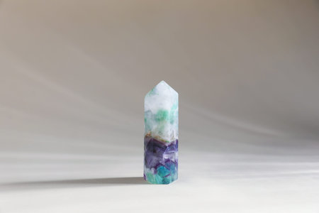 Aura. One beautiful crystal on beige background