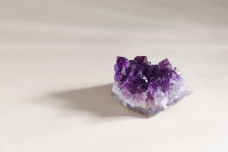 Aura. Beautiful amethyst on beige background. Space for text