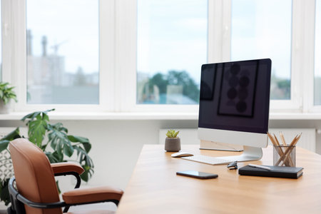 Stylish workplace with modern computer and stationery on wooden desk indoors