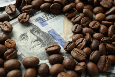 Dollar banknote and coffee beans on table, closeup