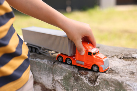 Little boy playing with toy outdoors, closeupの写真素材