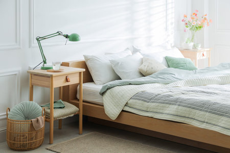 Bedside tables with decor near bed indoors