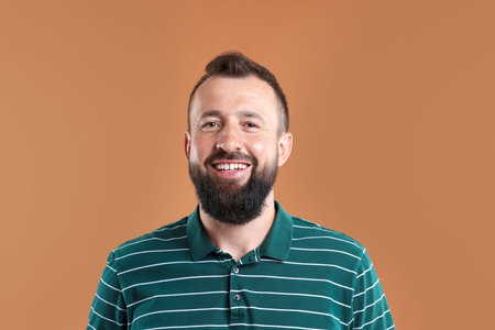 Man laughing on brown background. Positive emotion
