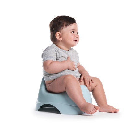Cute little baby sitting on potty against white backgroundの写真素材