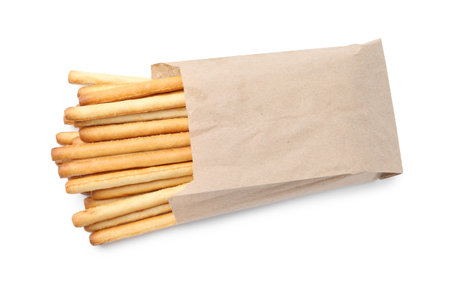 Grissini sticks in paper bag isolated on white, top view