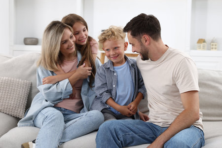 Happy family sitting on sofa at home