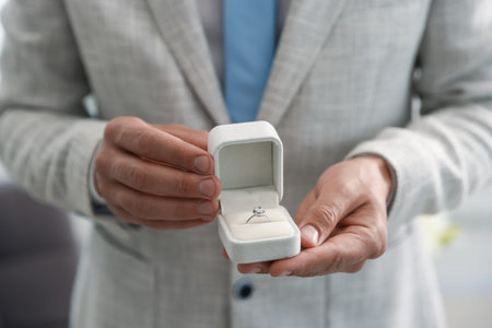 Making proposal. Man with engagement ring indoors, closeup