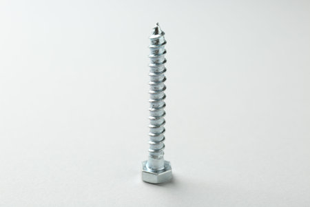 One metal bolt on light grey background. Hardware toolの写真素材