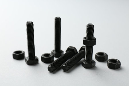 Metal bolts and nuts on white background, closeup. Hardware toolの写真素材