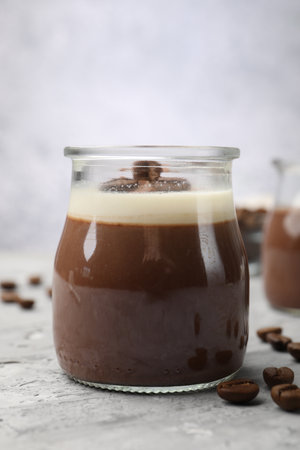 Delicious panna cotta and coffee beans on gray textured table, closeupの写真素材