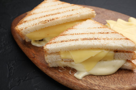 Tasty sandwiches with melted cheese on gray textured table, closeupの写真素材