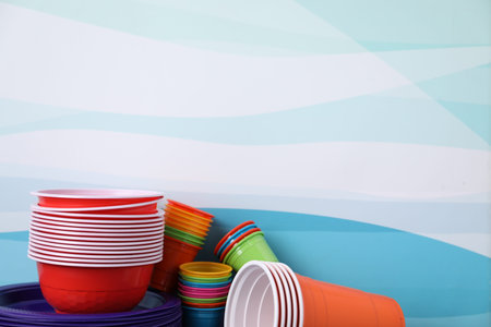 Set of disposable plastic dishware on color background, closeup. Space for textの写真素材