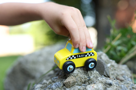 Little boy playing with toy outdoors, closeupの写真素材