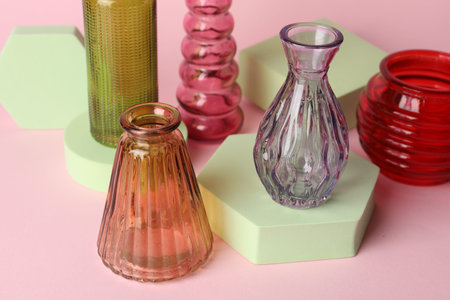 Different beautiful glass vases on pink background, closeupの写真素材