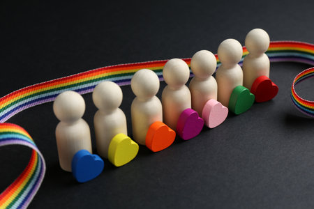 Tolerance concept. Human figures, colorful hearts and ribbon on black background, closeupの写真素材