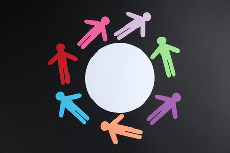 Tolerance concept. Colorful human figures and empty card on black background, flat lay. Space for...