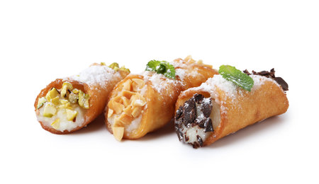 Delicious cannoli with cheese, nuts, powdered sugar, chocolate and mint isolated on whiteの写真素材
