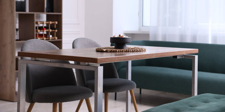 Wooden table with chairs, bench and decor in dining room. Interior designの写真素材