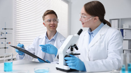 Medical analysis. Scientists working with microscope in laboratoryの写真素材