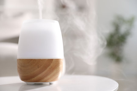 One stylish aroma lamp on white table indoors, closeup. Space for text