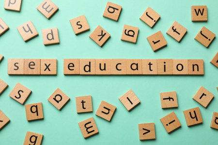 Words Sex Education made of wooden squares with letters on turquoise background, flat layの写真素材