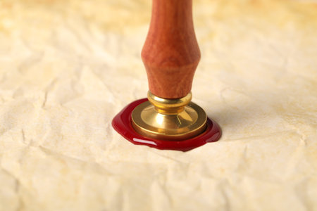 Sealing crumpled paper with wax stamp, closeup