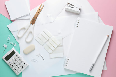 Different white stationery on color background, flat lay