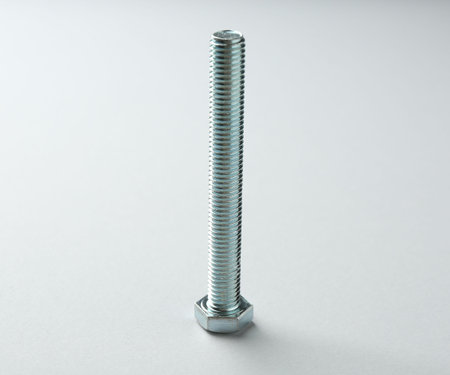 One metal bolt on white background. Hardware tool