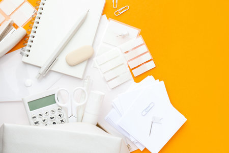 White stationery on orange background, flat lay. Space for text