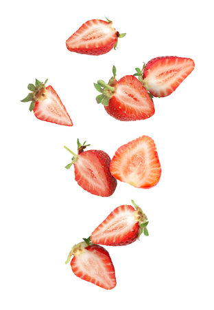 Cut fresh juicy strawberries falling on white backgroundの写真素材