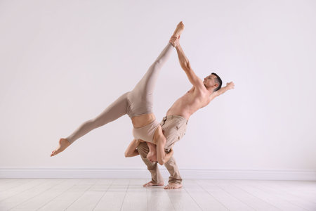 Couple of professional dancers training in studio